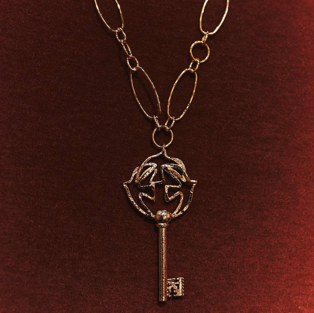 Pendentif doré Clé